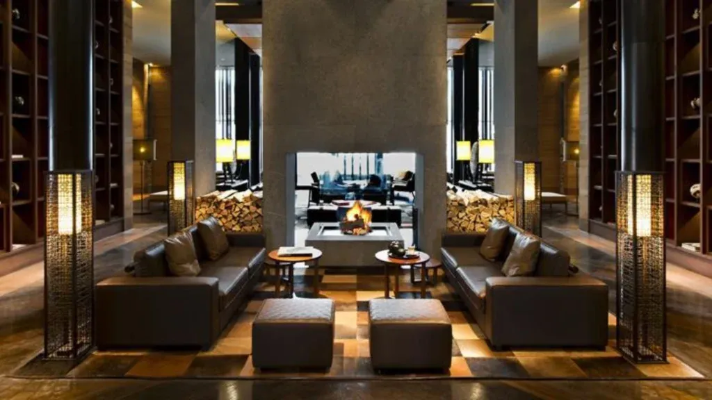 A luxurious seating area in The Chedi Andermatt hotel in front of a fire