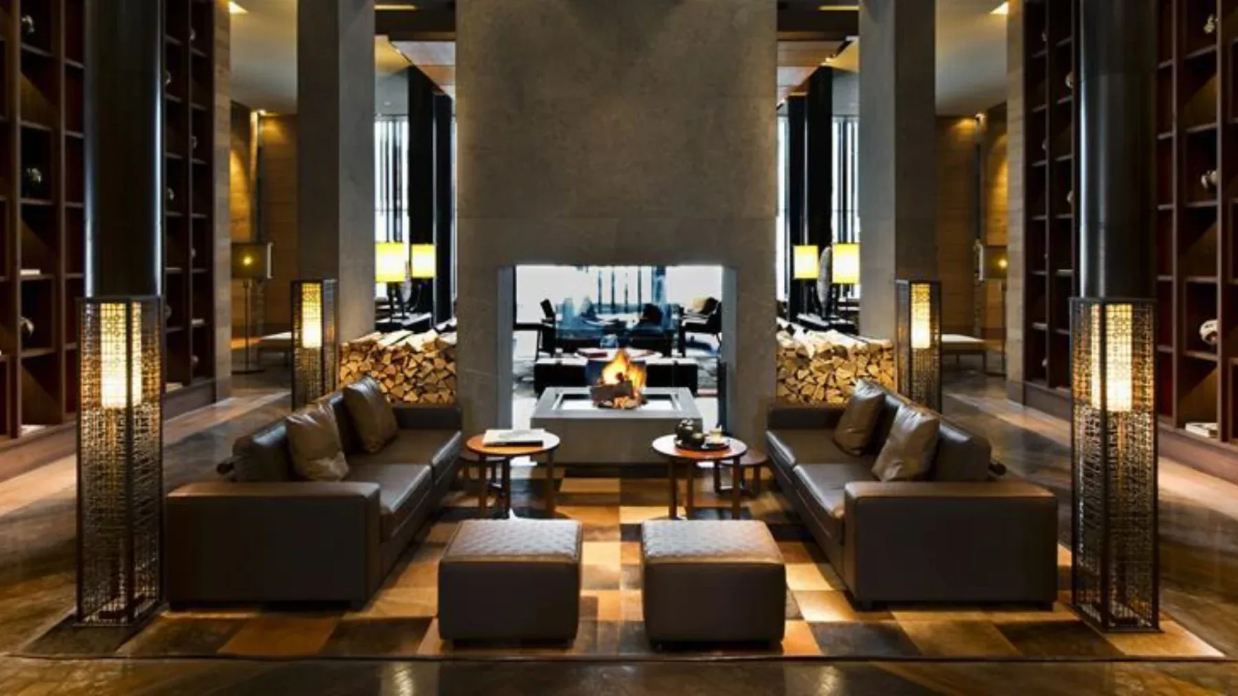 A luxurious seating area in The Chedi Andermatt hotel in front of a fire