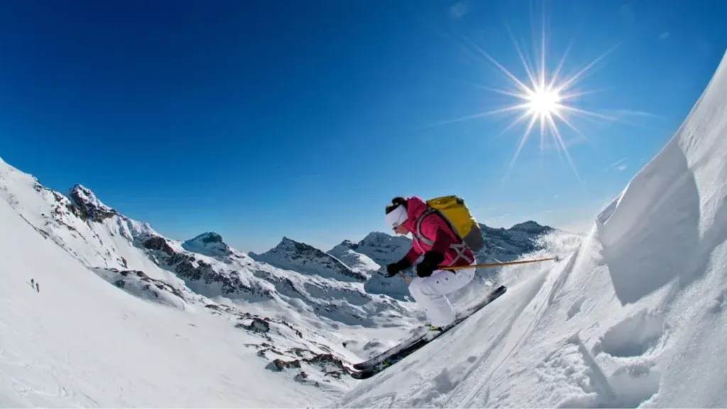 A group of skiers relaxing in front of a view of mountains