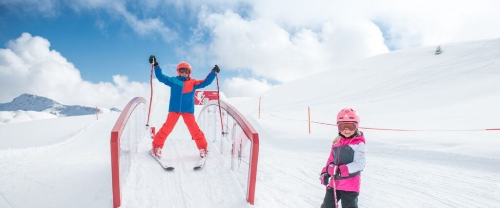 Two children skiing in a family ski area in Austria