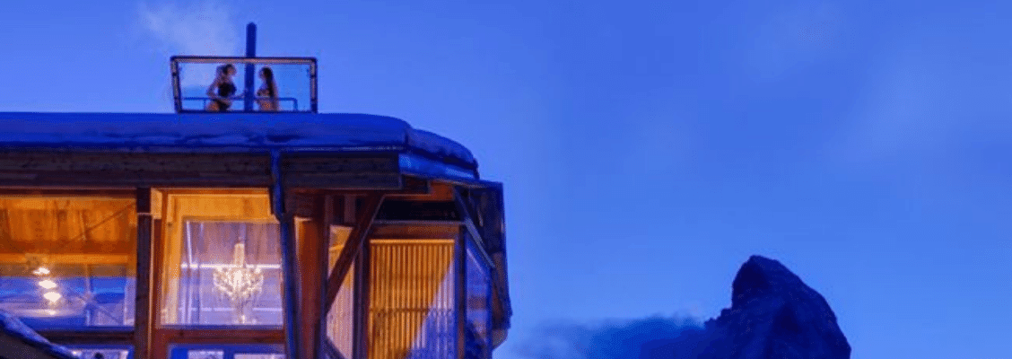 Two friends in a rooftop hot tub in a private ski chalet