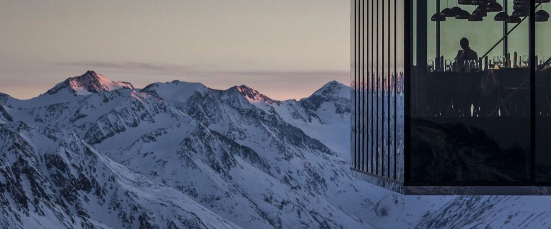 Glass-walled restaurant, perfect for luxury ski holidays