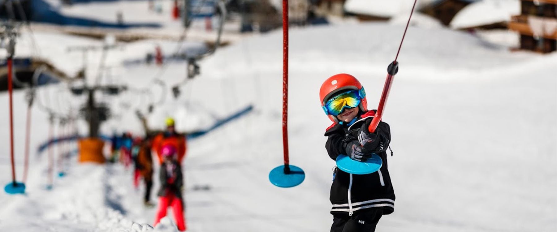 A child on a button ski lift