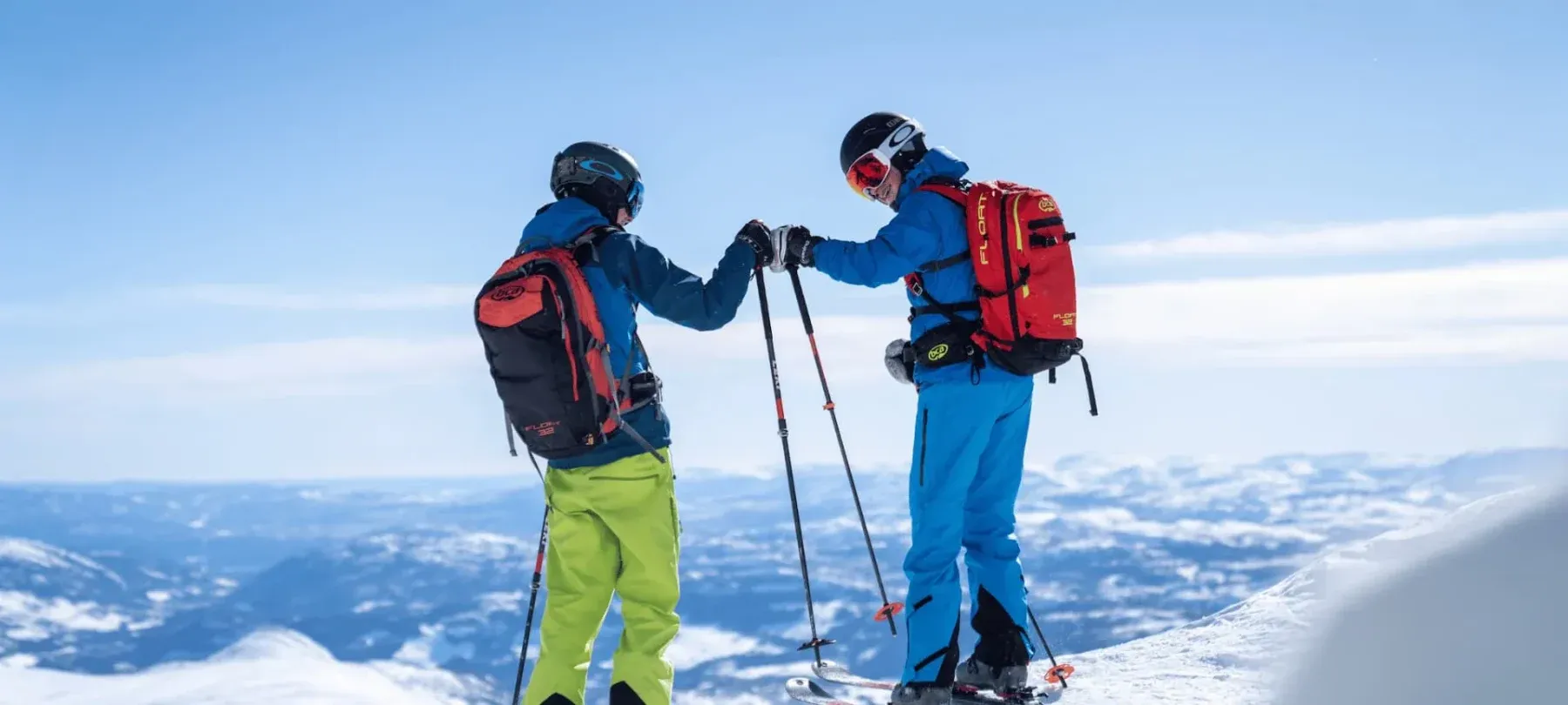 Friends on skis bumping hands before hitting the slopes